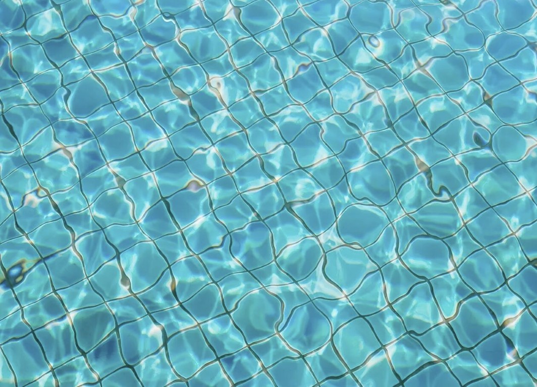 Crystal clear pool water surface showing clean filtration in Adelanto, CA